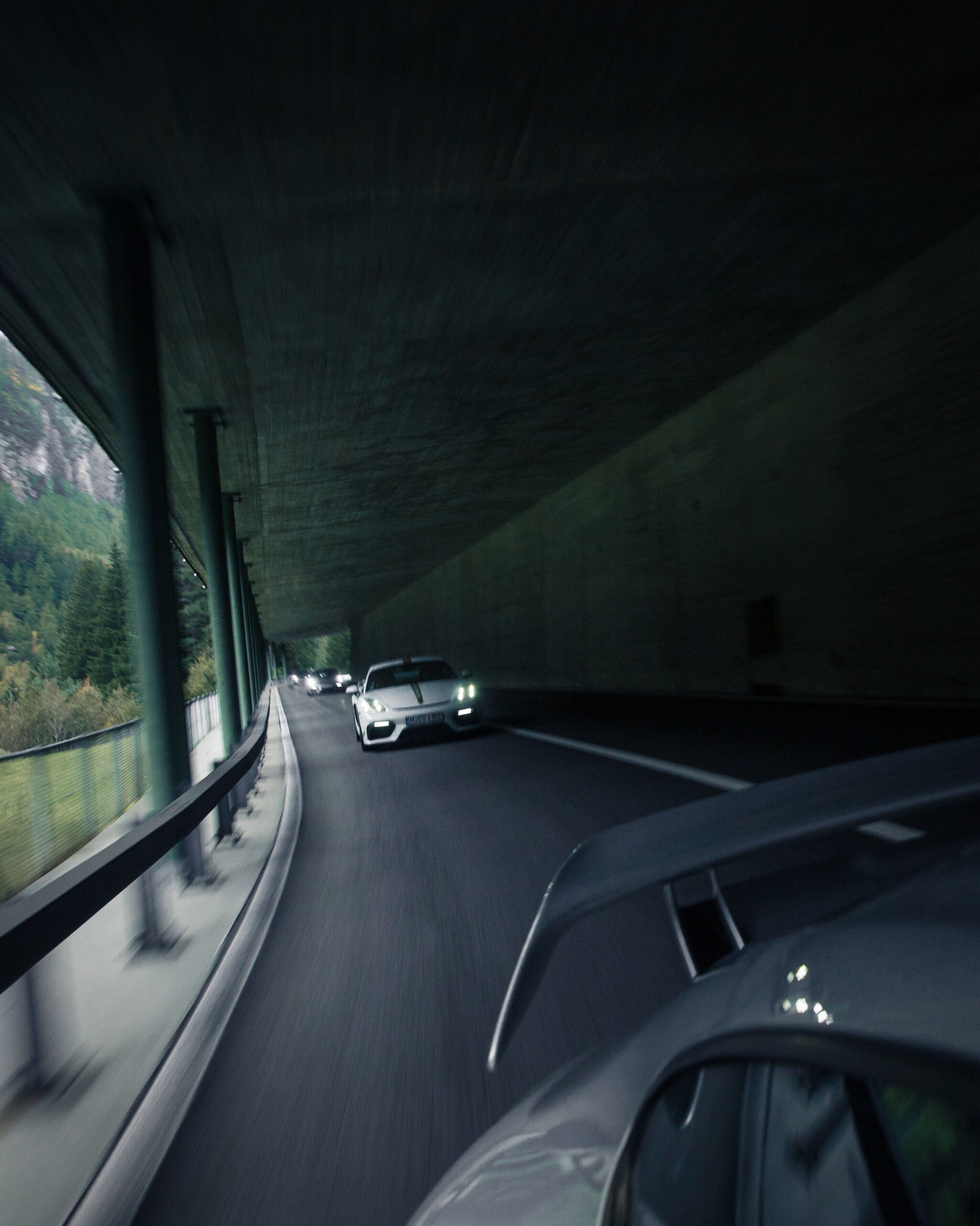 Porsche GT4 and GT2 driving in a tunnel in the Alps